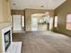Spacious living room with a fireplace, carpet floors, and an open view to the kitchen at 4013 Extenso Dr, North Las Vegas, NV 89032