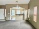 Inviting living area with carpet flooring, neutral walls, and an open view of the kitchen at 4013 Extenso Dr, North Las Vegas, NV 89032