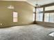 Expansive living room with a vaulted ceiling and carpet, filled with natural light at 4013 Extenso Dr, North Las Vegas, NV 89032