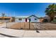 Charming single-story home with a xeriscaped front yard, chainlink fence, and a bright red front door at 4360 El Tovar Rd, Las Vegas, NV 89115