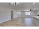 Open living space showcasing wood-look flooring, neutral paint, and an updated light fixture at 4360 El Tovar Rd, Las Vegas, NV 89115