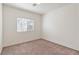 Cozy bedroom with neutral carpet, ample natural light from a window, and fresh, white walls at 4566 Mansart Ct # 1104, North Las Vegas, NV 89031