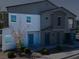 Two-story townhome featuring stucco facade and blue door for modern appeal at 4566 Mansart Ct # 1104, North Las Vegas, NV 89031