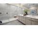 Bright bathroom features marble walk-in shower, dual sinks, and modern decor with a view from a skylight at 489 Carter House Way, Las Vegas, NV 89138
