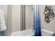Bright bathroom featuring a tiled shower-tub combo, modern hardware, and stylish blue ombre shower curtain at 489 Carter House Way, Las Vegas, NV 89138
