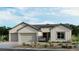 Beautiful single-story home showcasing a three-car garage and low-maintenance landscaping at 489 Carter House Way, Las Vegas, NV 89138