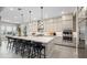 Modern kitchen features a large center island with seating, pendant lighting, gas cooktop and built-in appliances at 489 Carter House Way, Las Vegas, NV 89138