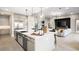 Bright kitchen boasts a large center island, pendant lights, modern appliances and is open to the adjacent living area at 489 Carter House Way, Las Vegas, NV 89138
