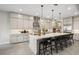 Modern kitchen with marble island, stainless steel appliances, pendant lighting, and sleek light-gray cabinets at 489 Carter House Way, Las Vegas, NV 89138
