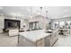 Open concept kitchen with a large island, modern lighting, and inviting living space at 489 Carter House Way, Las Vegas, NV 89138
