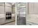 Modern kitchen with stainless steel appliances including a built-in double oven and refrigerator surrounded by sleek, light-colored cabinets at 489 Carter House Way, Las Vegas, NV 89138