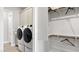 Convenient laundry room setup featuring a washer, dryer, and adjacent closet at 489 Carter House Way, Las Vegas, NV 89138