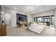 Spacious living room featuring a modern sectional sofa, stylish chandelier, and sliding glass doors to outdoor patio at 489 Carter House Way, Las Vegas, NV 89138