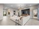 Open floor plan featuring living area with modern furnishings, adjacent dining space, and entry to bedroom with ensuite at 489 Carter House Way, Las Vegas, NV 89138