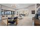 Bright living area with stylish furnishings, large windows, and seamless connection to modern kitchen at 489 Carter House Way, Las Vegas, NV 89138