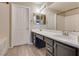 Bathroom features a dual sink vanity with a large mirror and bright lighting at 500 Quail Bird Pl, Henderson, NV 89052
