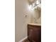 Powder room with single sink vanity, mirror and overhead lighting at 500 Quail Bird Pl, Henderson, NV 89052