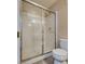 Bathroom showcases a glass-enclosed shower, tiled walls, and modern toilet at 500 Quail Bird Pl, Henderson, NV 89052