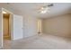 Large bedroom with carpet, ceiling fan, and multiple doorways at 500 Quail Bird Pl, Henderson, NV 89052