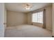 Spacious bedroom with plush carpet, ceiling fan and a large window at 500 Quail Bird Pl, Henderson, NV 89052
