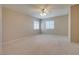 Spacious carpeted bedroom with a ceiling fan and ample natural light at 500 Quail Bird Pl, Henderson, NV 89052