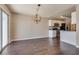 Open dining area next to the kitchen with a modern chandelier and sliding glass door at 500 Quail Bird Pl, Henderson, NV 89052
