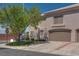 A view of the home's exterior featuring a two-car garage and desert landscaping at 500 Quail Bird Pl, Henderson, NV 89052