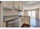 Kitchen sink and dishwasher with granite countertops and view to the patio at 500 Quail Bird Pl, Henderson, NV 89052