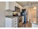 Kitchen with stainless steel appliances and gray countertops with breakfast bar at 500 Quail Bird Pl, Henderson, NV 89052