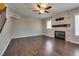 Cozy living room with hardwood floors, fireplace, and a ceiling fan at 500 Quail Bird Pl, Henderson, NV 89052