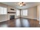 Bright living room with hardwood floors, fireplace, and large windows at 500 Quail Bird Pl, Henderson, NV 89052