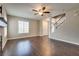 Open-concept living room with hardwood floors, fireplace, and staircase access at 500 Quail Bird Pl, Henderson, NV 89052