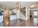 Open-concept living space with a kitchen, staircase, and modern lighting fixtures at 500 Quail Bird Pl, Henderson, NV 89052