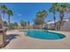 Relaxing community pool surrounded by mature palm trees under a clear blue sky at 500 Quail Bird Pl, Henderson, NV 89052