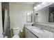 Bathroom featuring a granite vanity, framed mirror, and tiled shower with glass door at 5132 Springland St, Las Vegas, NV 89146