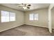 Standard bedroom with carpeted floors and natural light from two large windows at 5132 Springland St, Las Vegas, NV 89146