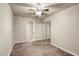 Standard bedroom with mirrored closet and carpeted floors, illuminated by a ceiling fan at 5132 Springland St, Las Vegas, NV 89146