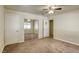 Bedroom with mirrored closet, carpeted floors, and ceiling fan at 5132 Springland St, Las Vegas, NV 89146