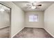 Standard bedroom with mirrored closet and carpeted floors, featuring a ceiling fan at 5132 Springland St, Las Vegas, NV 89146