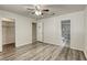 Bright bedroom features wood-look flooring, ceiling fan, and ensuite bathroom at 5132 Springland St, Las Vegas, NV 89146