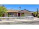 Inviting single-story house with well-maintained landscaping and a classic white picket fence at 5132 Springland St, Las Vegas, NV 89146