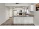 Updated kitchen features white cabinetry, sleek countertops and stainless steel appliances at 5132 Springland St, Las Vegas, NV 89146
