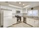 Updated kitchen with white cabinets, stainless steel appliances, and granite countertops at 5132 Springland St, Las Vegas, NV 89146