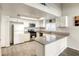 Well-lit kitchen with white cabinetry, granite countertops, and stainless steel appliances at 5132 Springland St, Las Vegas, NV 89146