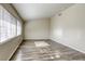 Bright living room featuring wood-look floors and natural light from large windows at 5132 Springland St, Las Vegas, NV 89146