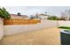 Fenced backyard with rock landscaping and strip of artificial turf at 5151 Tennis Ct, Las Vegas, NV 89120