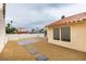 The backyard has rock landscaping and a row of stepping stones at 5151 Tennis Ct, Las Vegas, NV 89120