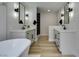 Bright bathroom with double sinks, soaking tub, and modern fixtures at 5151 Tennis Ct, Las Vegas, NV 89120