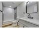 Modern bathroom with marble-look tile shower, new fixtures and floating vanity at 5151 Tennis Ct, Las Vegas, NV 89120