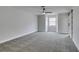 Spacious bedroom with soft carpet, fan, and natural light from window at 5151 Tennis Ct, Las Vegas, NV 89120